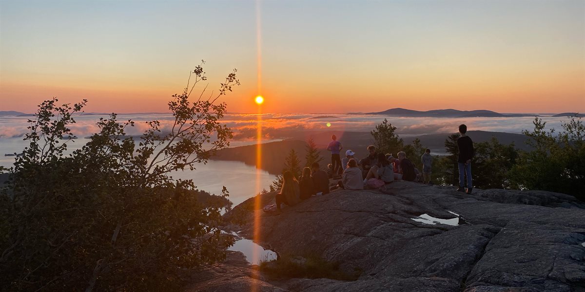 Boys watching sunset on Lake Winnipesaukee
