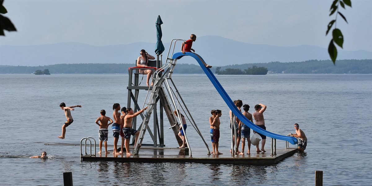Boys playing on Lake Winnipesaukee with water slide