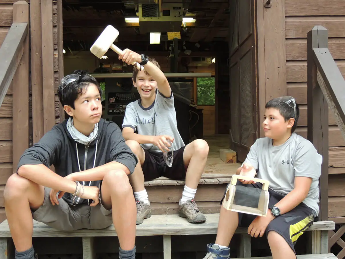 Boys smiling in front of Kabeyun cabins