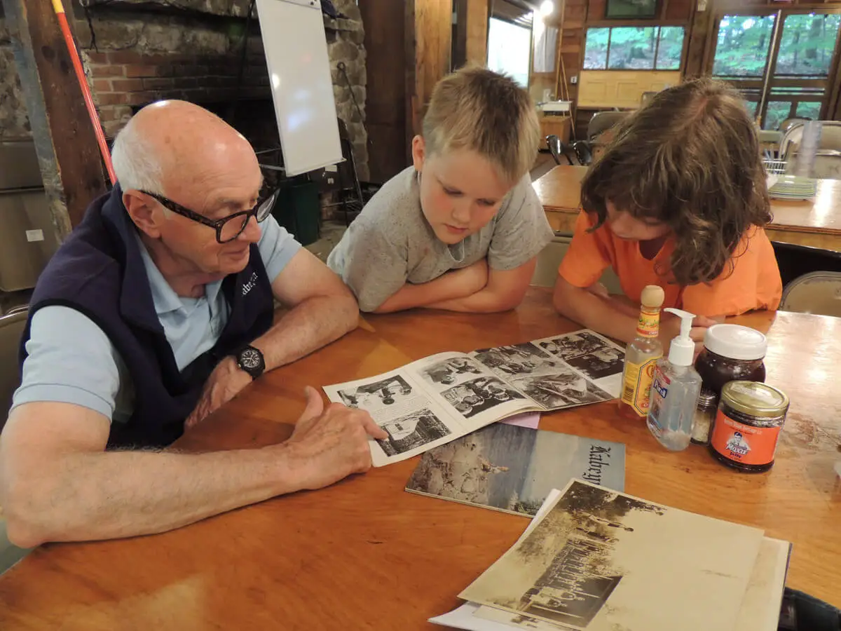 Past camper sharing stories with young campers