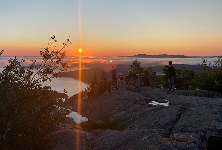 Boys watching sunset on Lake Winnipesaukee