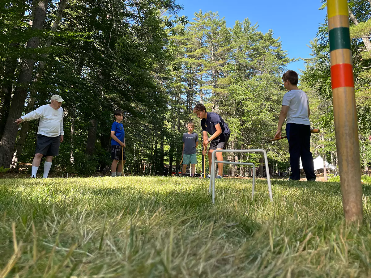 Boys playing croquet 