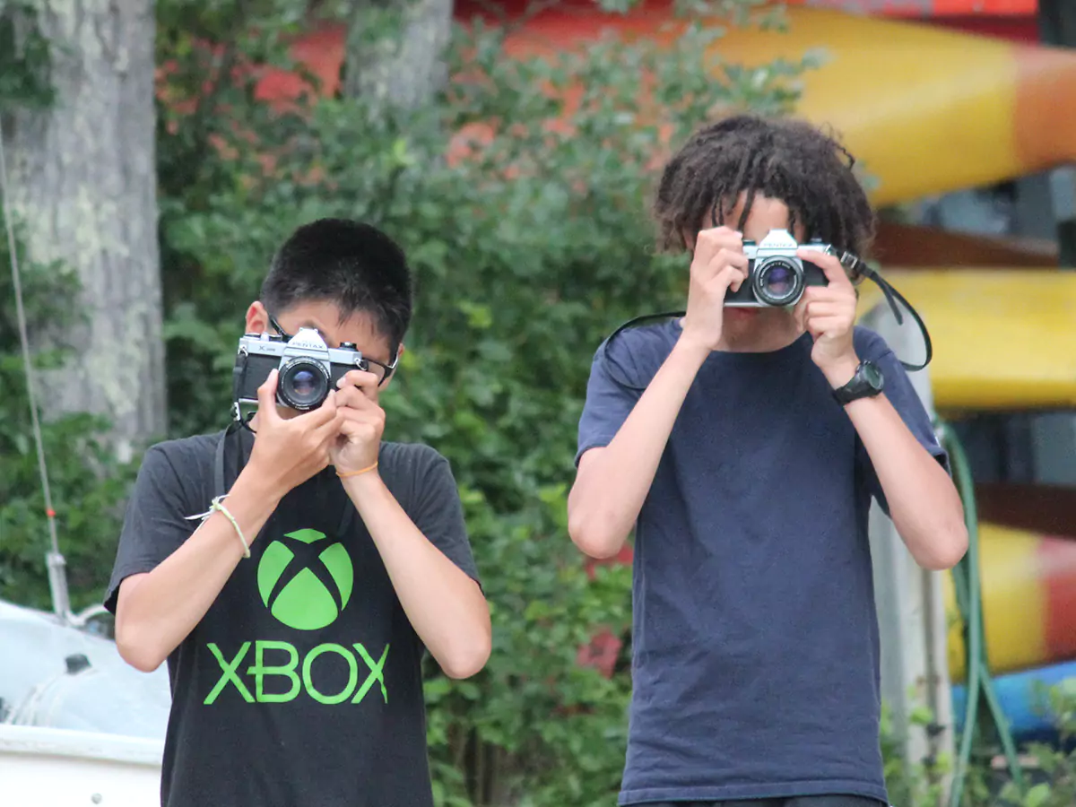 Boy taking pictures in photography class 