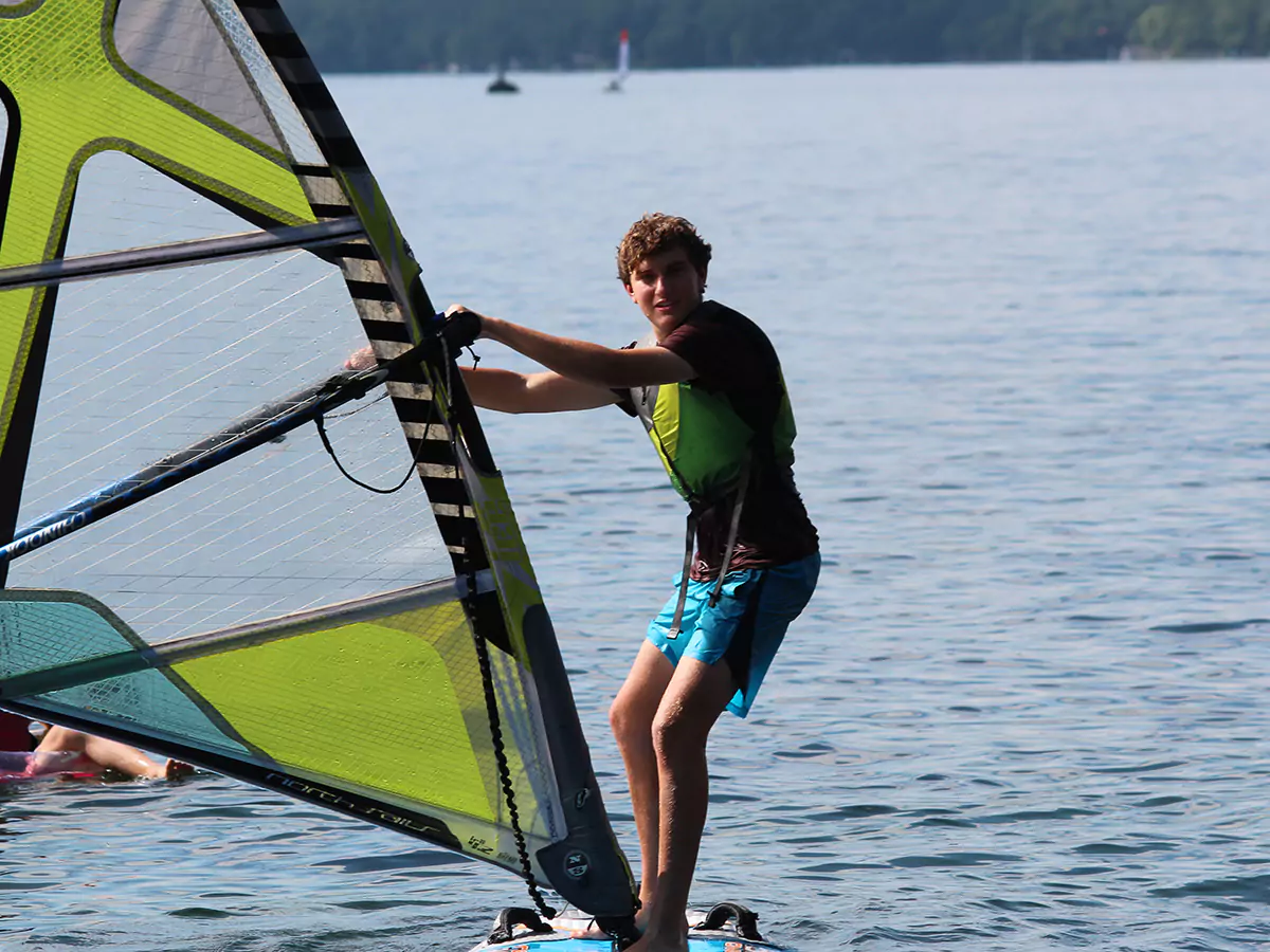 Boy windsurfing on Lake Winnipesaukee