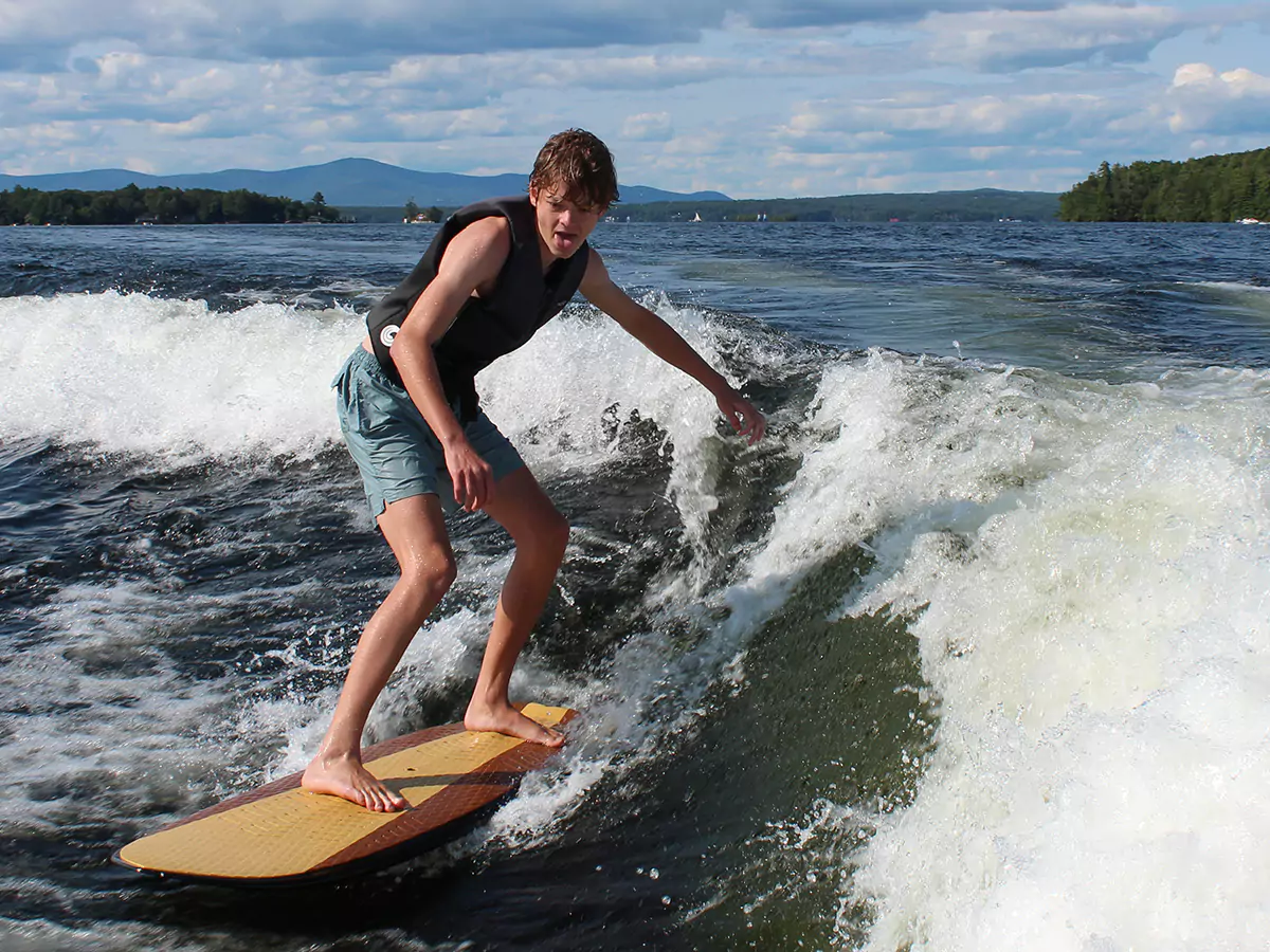 Boy wake surfing on Lake Winnipesaukee