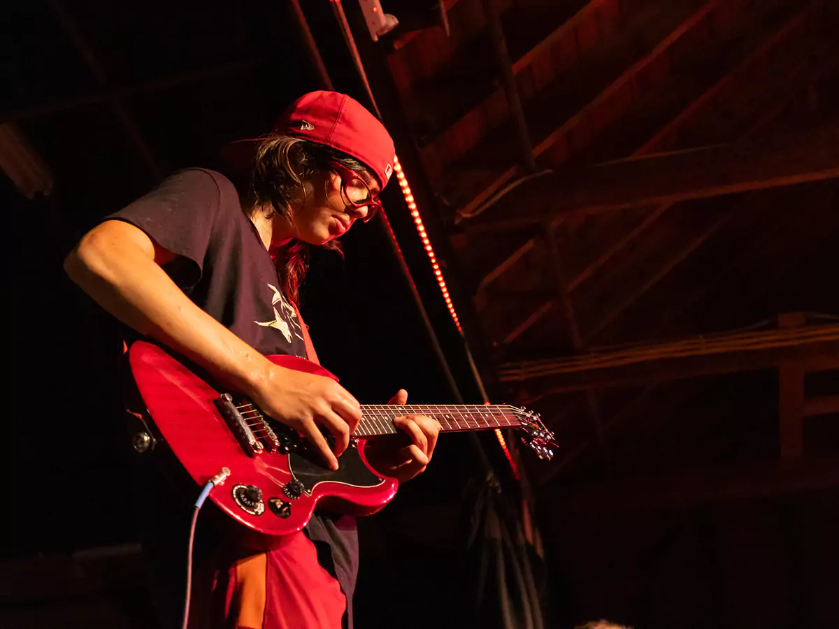 Two boys playing music together at Camp Kabeyun 