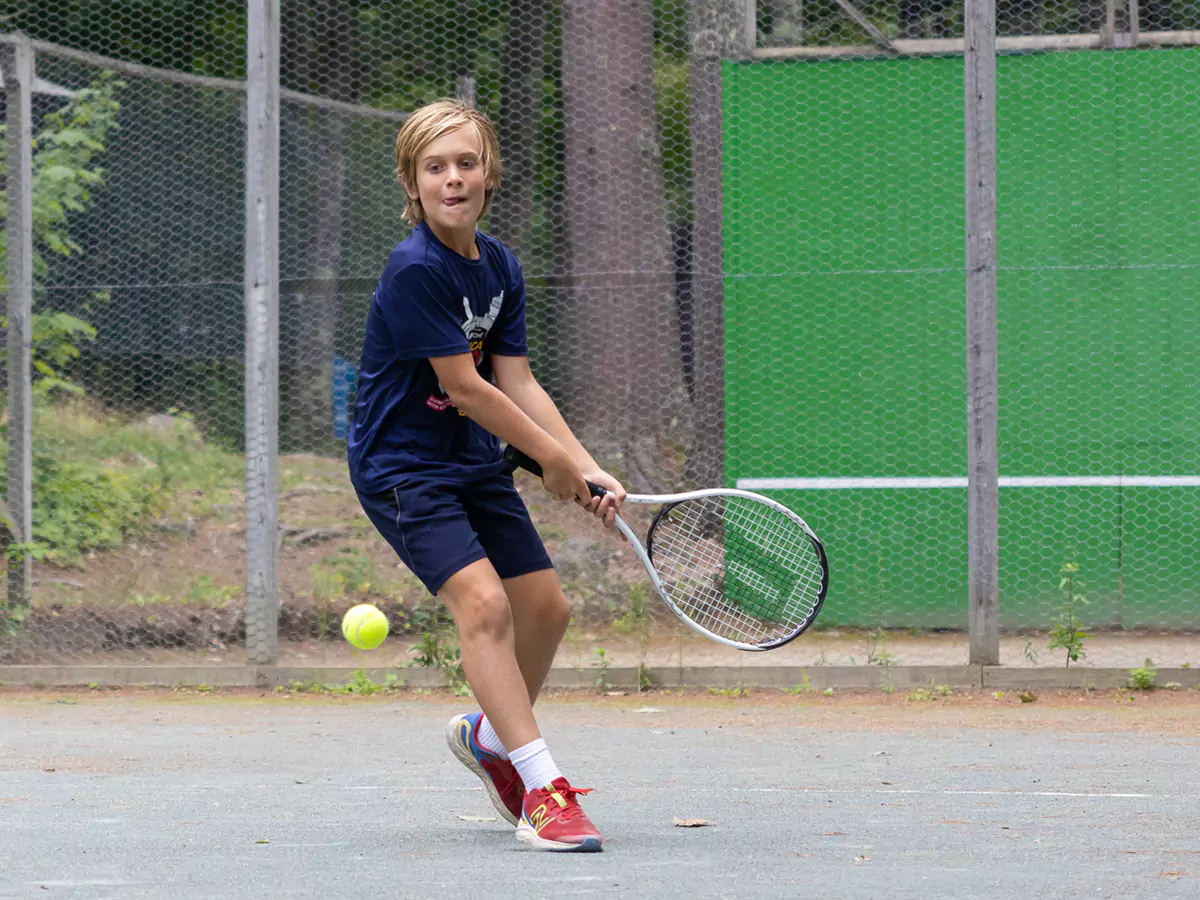 Boy playing tennis at Kabeyun 