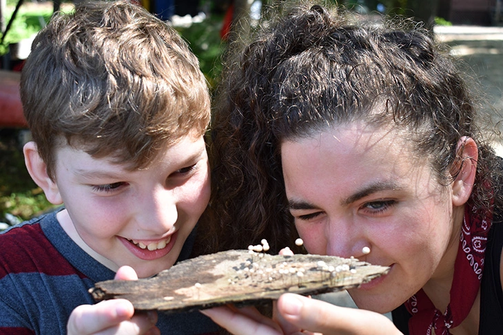 Boy experiencing nature with Kabeyun camp counselor 